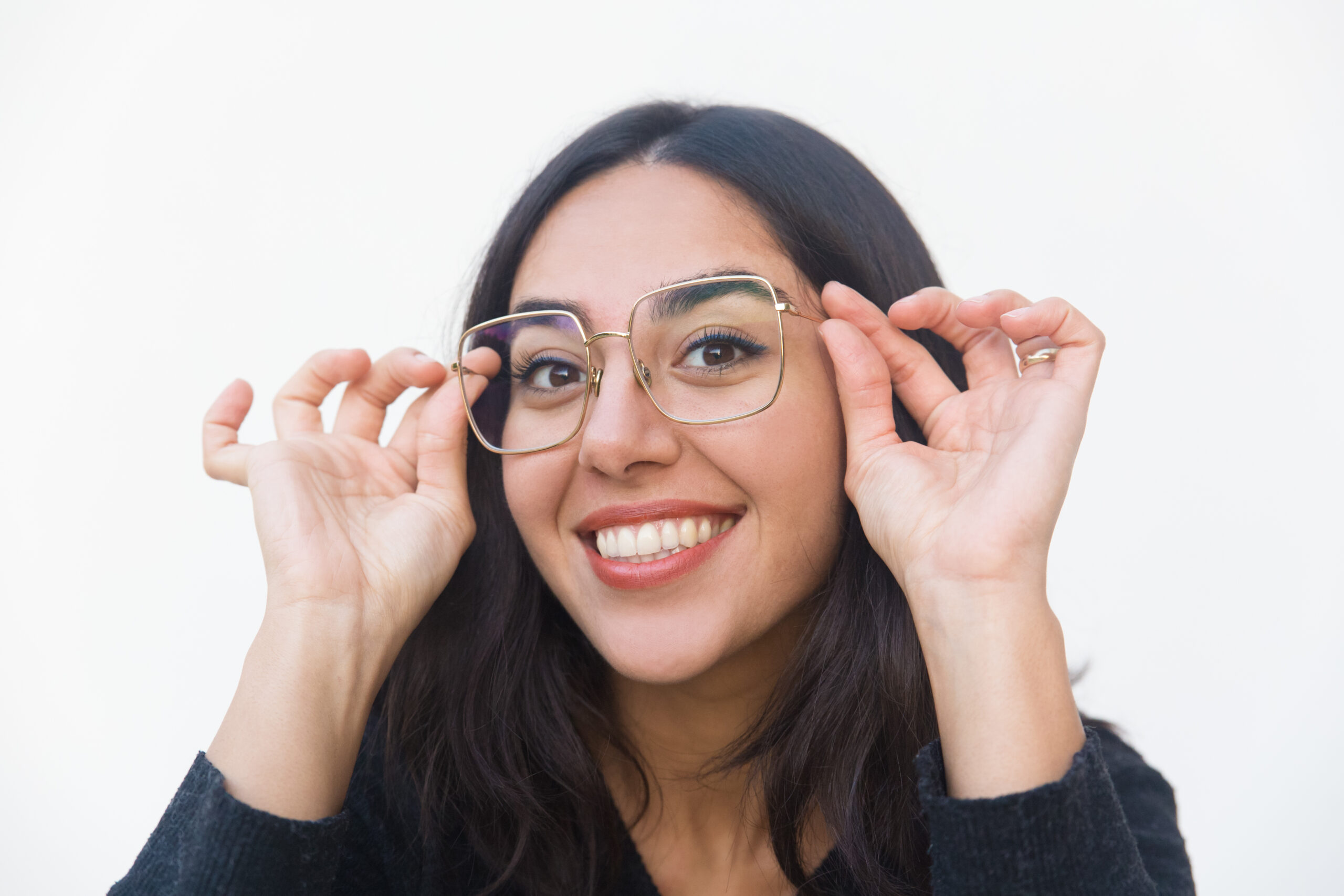 Closeup of happy joyful woman adjusting glasses